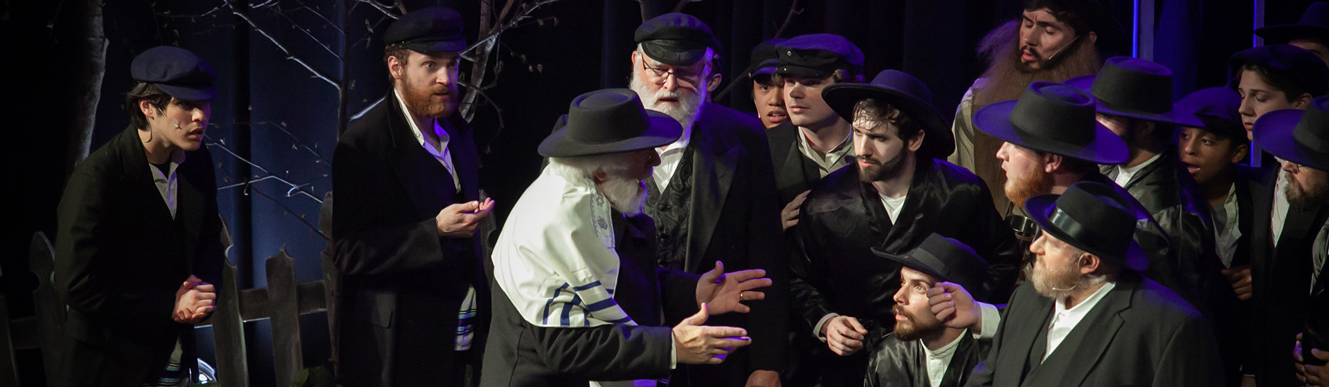 a group of men in hats are standing around a man with a beard